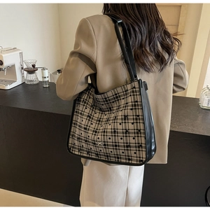 Plaid canvas tote bag with bow detail shown in a casual cafe lifestyle setting