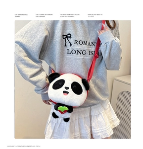 Detail of panda plush crossbody bag showing soft fur texture and strawberry embroidery
