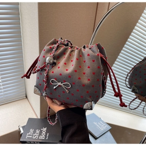 Minimalist fabric bucket crossbody bag with red hearts, silver bow and chain strap