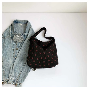 Minimalist black corduroy tote bag with red strawberry pattern and acrylic chain strap