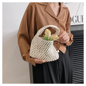 Detail of white woven crochet handbag texture with chunky cotton rope and hobo handle