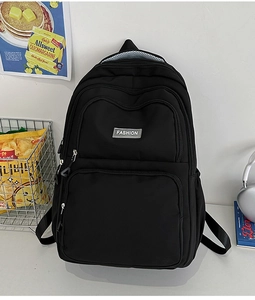 Detail view of durable black nylon backpack with multi-layer zippers and fashion label