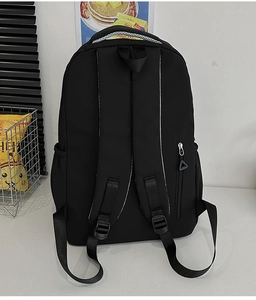 Detailed back view of nylon backpack with ergonomic S-shaped straps and hidden zipper pocket