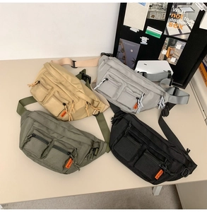 Detail of four multi-pocket nylon waist bags in khaki, grey, green, and black colors