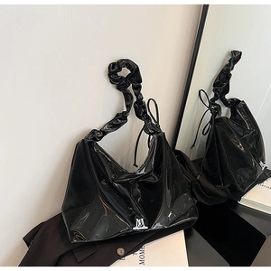 Minimalist black glossy PU leather shoulder bag with a unique scrunchie style handle