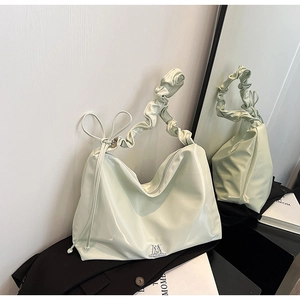 Mint green glossy PU leather tote bag with ruched shoulder strap and silver logo