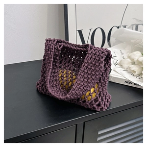Close-up of deep purple hand-woven mesh tote bag with thick cotton rope texture