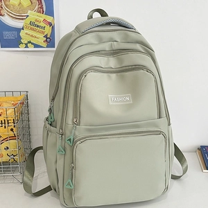 Minimalist light green nylon backpack with multiple zippered pockets for daily use