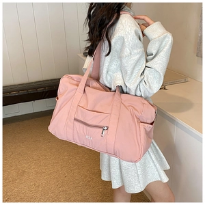 Close-up of lightweight light pink nylon tote bag with large capacity and brand logo