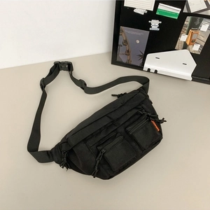 Minimalist black nylon waist bag with multi-pocket design and adjustable strap