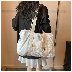 White nylon tote bag featuring crinkle texture and VETTA embroidery on a shoulder strap
