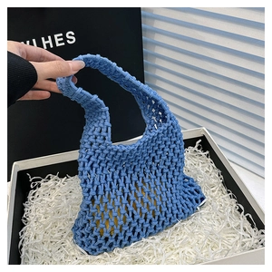 Detailed shot of sky blue hand-woven net bag with cotton rope texture in gift box