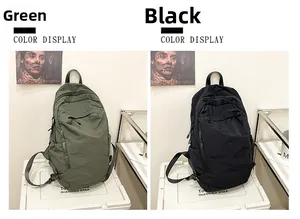 Detail view of green and black washed fabric backpacks with minimalist zipper design