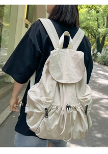Outdoor shot of beige nylon drawstring backpack with large capacity and side pockets