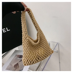 Detail of woven beige handbag showing textured rope craft and mesh structure
