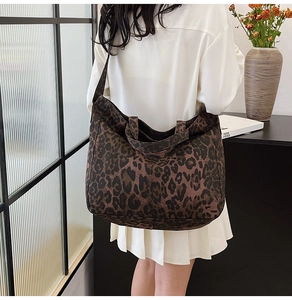 Lifestyle shot of large leopard print canvas tote bag styled with a minimalist outfit
