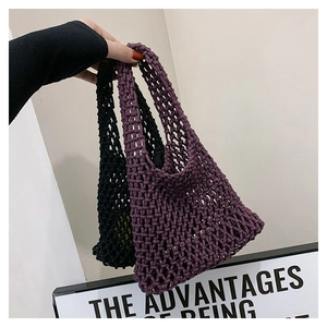 Detailed texture of hand-woven mesh tote bags in purple and black cotton yarn