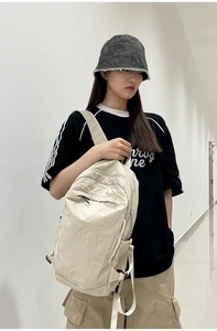 Close-up of lightweight washed nylon backpack in cream white with FLY10 logo detail