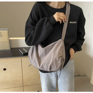 Detail of adjustable drawstring on lightweight nylon cloud bag with pleated texture