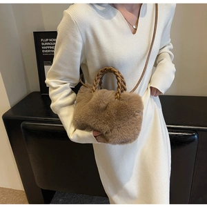 Close-up of brown plush crossbody bag featuring unique woven handles and soft faux fur texture