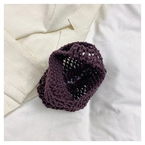 Close-up of deep purple woven handbag featuring honeycomb mesh texture and inner lining