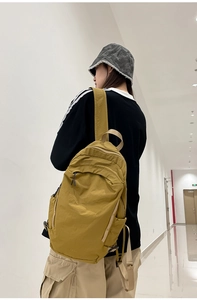 Close-up of a mustard yellow washed nylon backpack with water-resistant texture