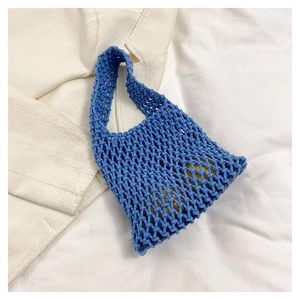 Detailed view of hand-woven blue tote bag with a unique hollow rope mesh texture