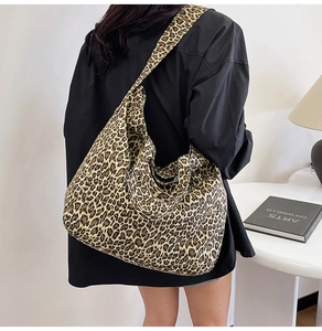 Detail of trendy leopard print canvas tote bag featuring wide strap and large capacity