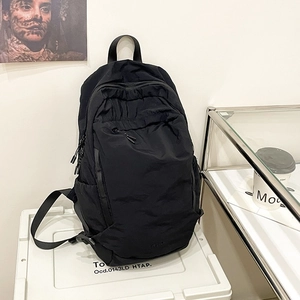 Versatile black washed fabric backpack for women with minimalist wrinkled nylon texture