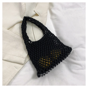 Handmade black woven tote bag with yellow inner pouch and vintage crochet mesh design