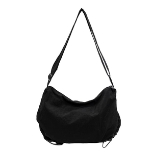 Minimalist black crescent nylon crossbody bag with adjustable wide shoulder strap for women