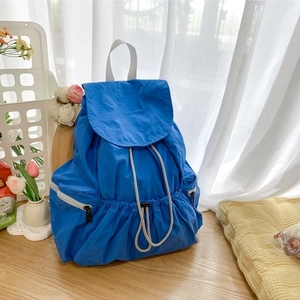 Royal blue nylon backpack with drawstring closure and silver zip pockets for summer travel