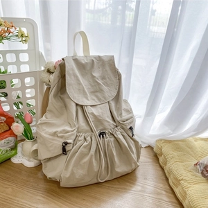 Minimalist beige nylon backpack for women with drawstring closure and side zipper pockets