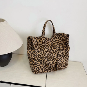 Minimalist leopard print canvas tote bag with dual handles and wide shoulder strap