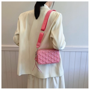 Dettaglio borsa a tracolla rosa in PU trapuntato con motivo a onde ed elegante nappa sulla zip