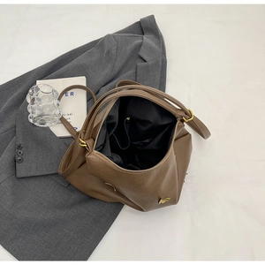 Top view of brown PU leather tote bag with gold bird ornament and spacious interior