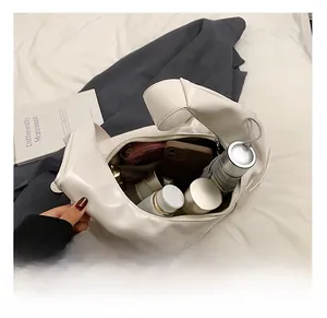 Detail showing high-capacity interior of white soft PU leather shoulder bag for daily items