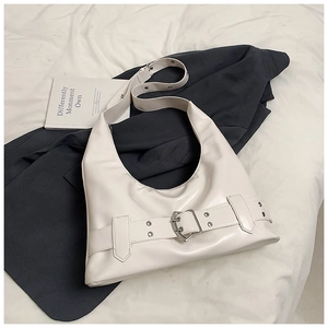 Close-up of cream PU leather shoulder bag featuring wide strap and metallic buckle detail