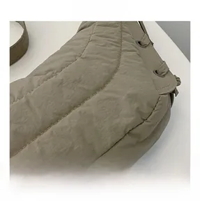 Detailed macro view of khaki quilted bubble fabric texture and sleek metallic eyelets