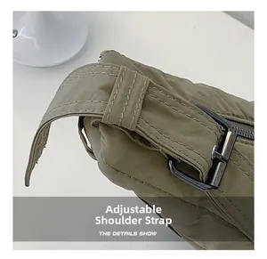 Close-up of adjustable nylon shoulder strap with metal buckle and fine double stitching