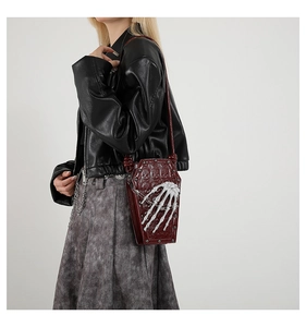 Gothic red coffin shoulder bag with 3D bone hand and chain shown on a model