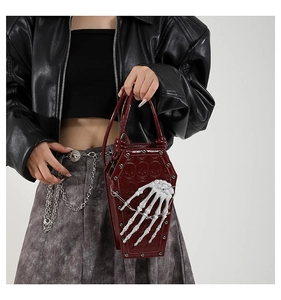 Gothic coffin handbag in burgundy faux leather with skull embossing and bone handle detail