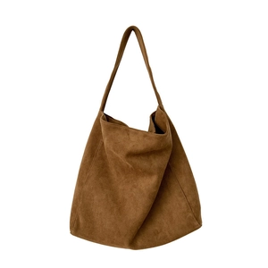 Brown suede tote bag with a minimalist slouchy design and wide shoulder strap