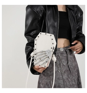 White coffin-shaped PU leather crossbody bag with 3D skull hand on a model