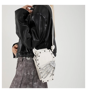 White coffin-shaped shoulder bag with skull hand detail in Gothic punk style