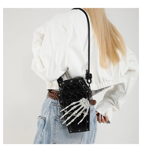 Detailed view of black PU leather coffin bag with white skeleton hand and skull patterns