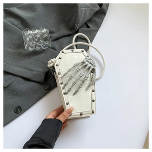 White coffin shaped crossbody bag with gothic skull embossing and skeletal hand detail