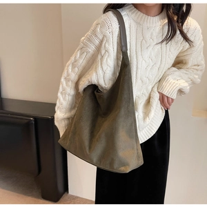 Close-up of olive green suede tote bag showing its soft texture and slouchy drape