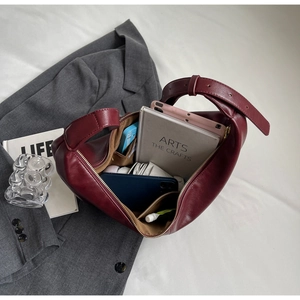 Detail view of burgundy PU leather shoulder bag showing spacious interior and wide strap