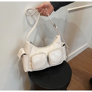 Close-up detail of cream white PU leather crossbody bag with multiple functional pockets